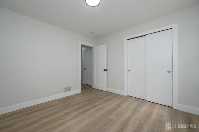 144 Elm St, Dover, NJ 07801 - unfurnished bedroom featuring wood finished floors and a closet