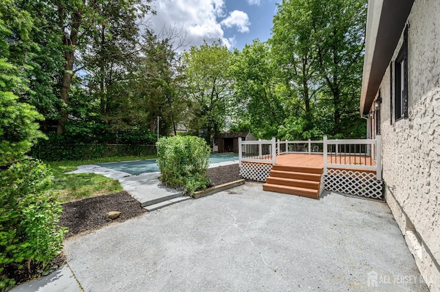 144 Elm St, Dover, NJ 07801 - view of patio with a wooden deck and view of wooded area