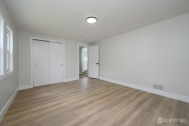 144 Elm St, Dover, NJ 07801 - unfurnished bedroom with light wood-style floors and a closet