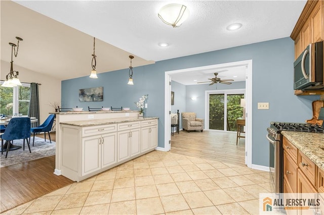 kitchen with appliances with stainless steel finishes, ceiling fan, healthy amount of natural light, pendant lighting, and recessed lighting