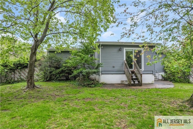 rear view of property with entry steps and a patio area