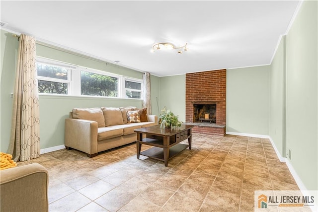 living area featuring baseboards, a brick fireplace, and ornamental molding
