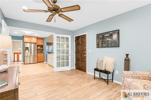 sitting room featuring light wood-style floors, a ceiling fan, baseboards, and recessed lighting