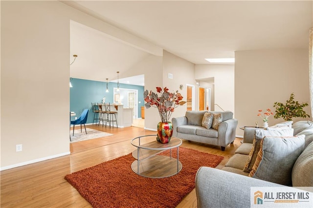 living room with light wood-type flooring and baseboards