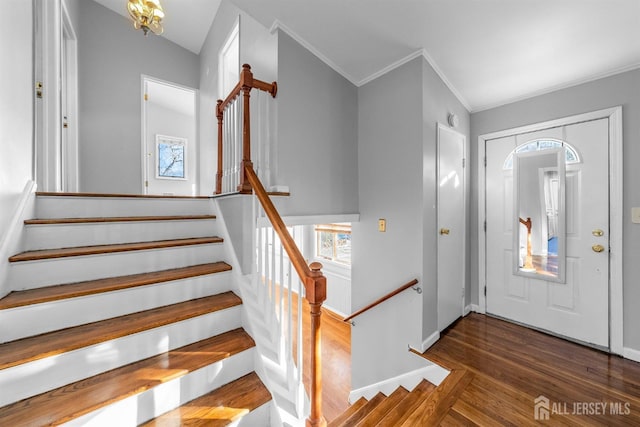 foyer entrance featuring crown molding, stairs, baseboards, and dark wood-style flooring