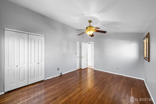 unfurnished bedroom featuring a ceiling fan, baseboards, and dark wood-type flooring