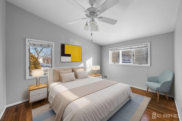 bedroom featuring dark wood-style floors, lofted ceiling, ceiling fan, and baseboards