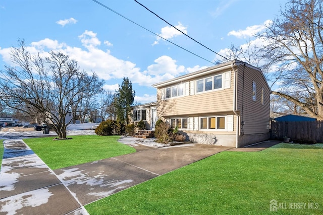 view of front of home with fence and a front yard