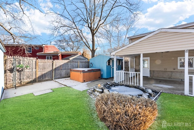 view of yard with fence private yard, a patio, and a hot tub