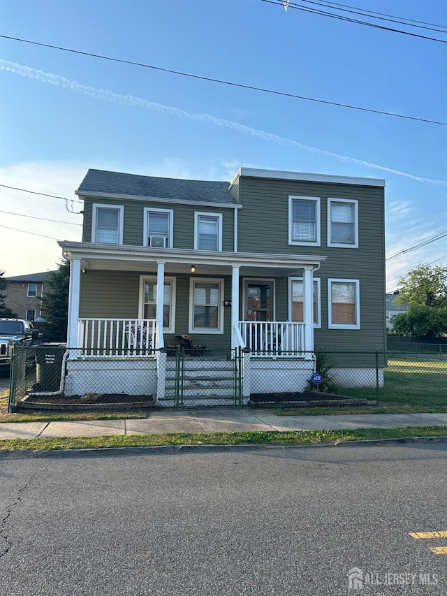 view of front of home featuring a fenced front yard, covered porch, and a gate