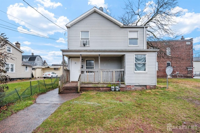 view of property with a porch and a front lawn