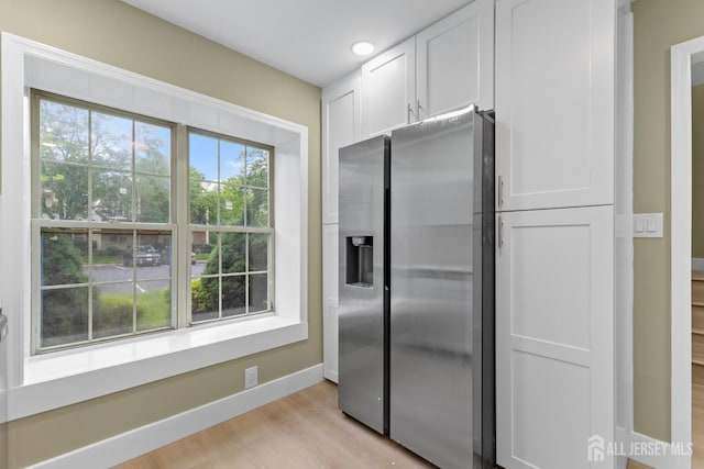 13 Stuart Dr Unit 5, Freehold, NJ 07728 - kitchen featuring stainless steel fridge, white cabinetry, and light wood-style floors