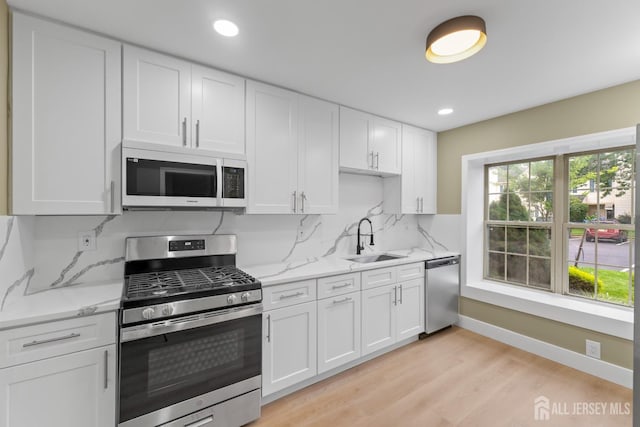 13 Stuart Dr Unit 5, Freehold, NJ 07728 - kitchen featuring stainless steel appliances, white cabinets, light wood-style flooring, light stone counters, and recessed lighting