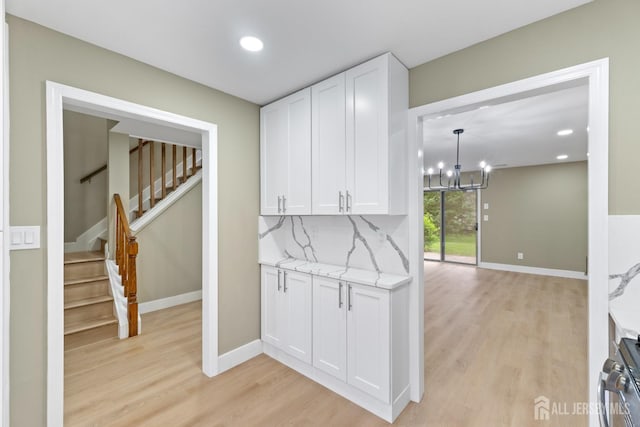 13 Stuart Dr Unit 5, Freehold, NJ 07728 - hall featuring light wood-style flooring, a chandelier, stairway, and recessed lighting