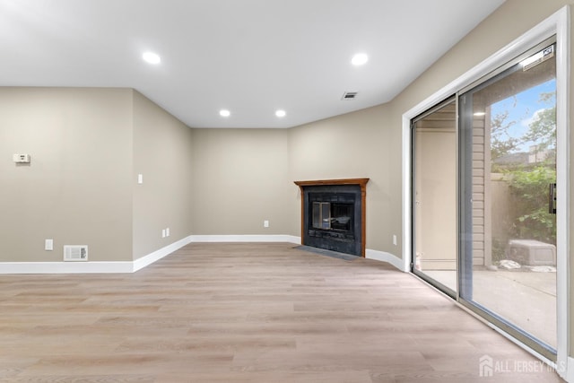 13 Stuart Dr Unit 5, Freehold, NJ 07728 - unfurnished living room featuring light wood-type flooring, a fireplace with flush hearth, and recessed lighting