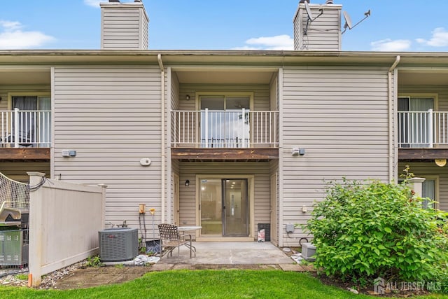 13 Stuart Dr Unit 5, Freehold, NJ 07728 - rear view of house featuring a balcony, a chimney, and a patio