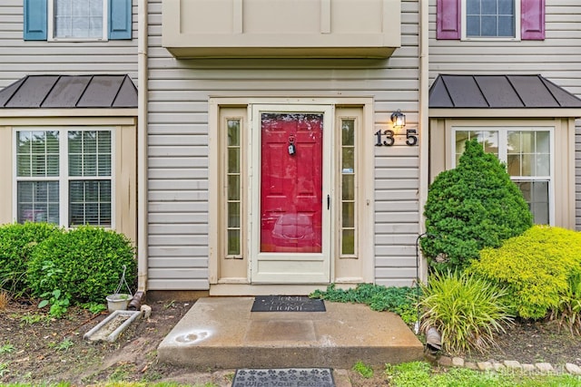 13 Stuart Dr Unit 5, Freehold, NJ 07728 - view of exterior entry featuring a standing seam roof and a metal roof
