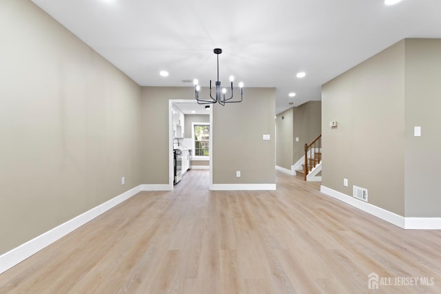 13 Stuart Dr Unit 5, Freehold, NJ 07728 - unfurnished dining area featuring light wood-style flooring, recessed lighting, a chandelier, and stairway