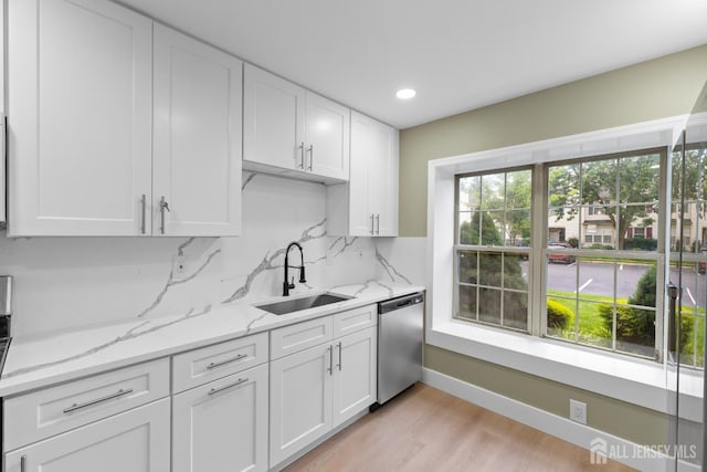 13 Stuart Dr Unit 5, Freehold, NJ 07728 - kitchen featuring stainless steel dishwasher, white cabinets, light wood-style floors, recessed lighting, and light stone countertops