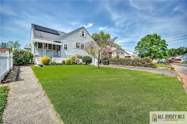 146 Arlington Dr, Fords, NJ 08863 - view of front of home with solar panels and a shingled roof