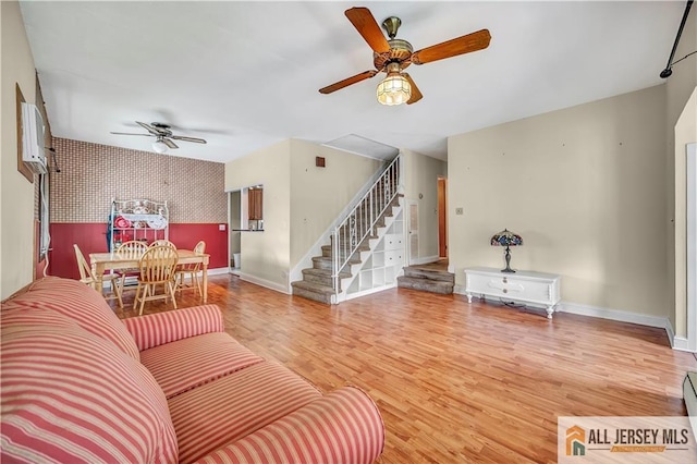 146 Arlington Dr, Fords, NJ 08863 - living room featuring ceiling fan, an accent wall, wallpapered walls, baseboards, and stairs