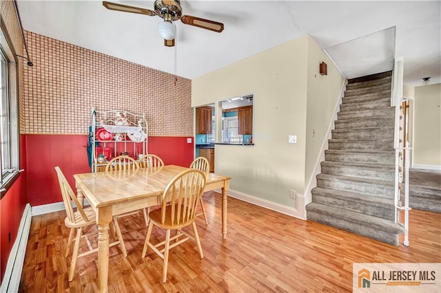 146 Arlington Dr, Fords, NJ 08863 - dining room featuring a baseboard radiator, ceiling fan, stairs, baseboards, and wood finished floors
