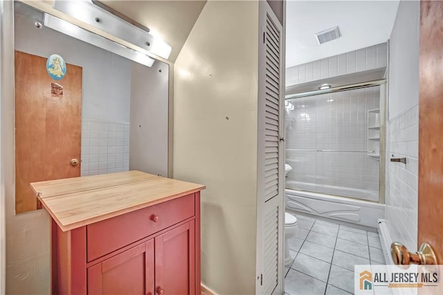 146 Arlington Dr, Fords, NJ 08863 - bathroom with toilet, tile patterned floors, enclosed tub / shower combo, tile walls, and vanity