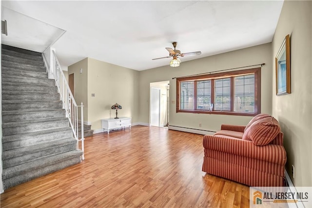 146 Arlington Dr, Fords, NJ 08863 - living room with a baseboard radiator, a ceiling fan, wood finished floors, stairs, and baseboards