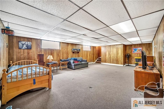 146 Arlington Dr, Fords, NJ 08863 - bedroom with wood walls, carpet floors, a paneled ceiling, and a baseboard heating unit