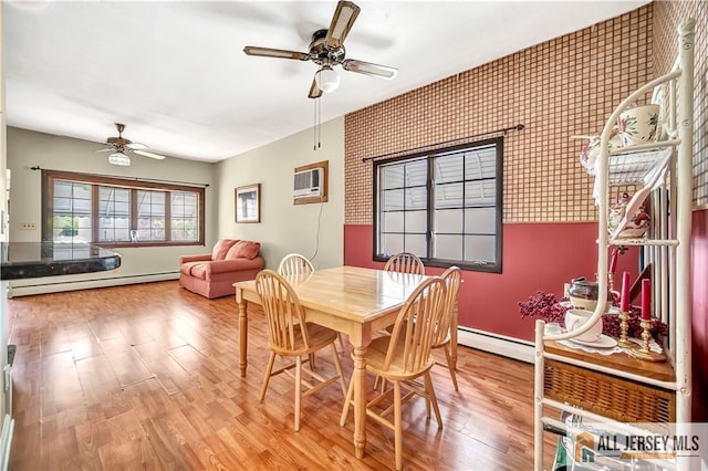 146 Arlington Dr, Fords, NJ 08863 - dining space with a baseboard radiator, ceiling fan, a baseboard heating unit, an AC wall unit, and wood finished floors