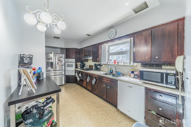 292 Morton Ave, Rahway, NJ 07065 - kitchen featuring stainless steel appliances, a sink, a warming drawer, a chandelier, and dark brown cabinets