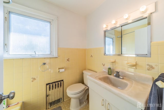 292 Morton Ave, Rahway, NJ 07065 - bathroom with radiator, tile walls, vanity, wainscoting, and tile patterned flooring