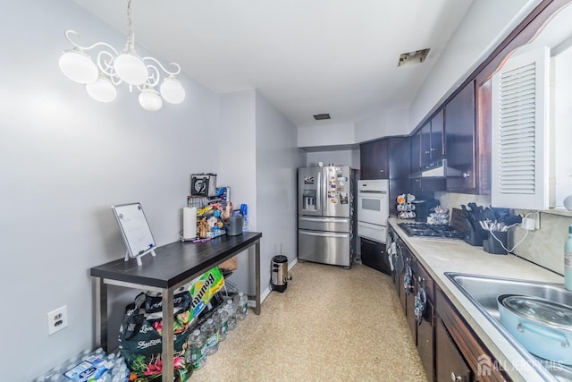292 Morton Ave, Rahway, NJ 07065 - kitchen featuring stainless steel appliances, a warming drawer, light countertops, under cabinet range hood, and baseboards