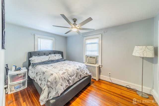 292 Morton Ave, Rahway, NJ 07065 - bedroom featuring radiator, multiple windows, wood finished floors, and baseboards