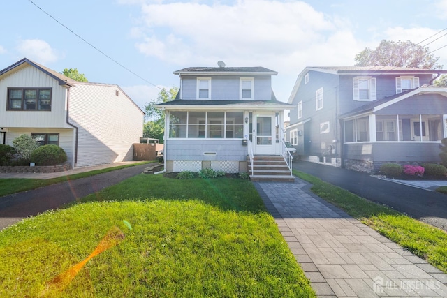 292 Morton Ave, Rahway, NJ 07065 - view of front of home with a sunroom and a front yard