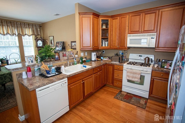 116 Prusakowski Blvd, Sayreville, NJ 08859 - kitchen with a sink, light wood finished floors, white appliances, brown cabinetry, and a peninsula