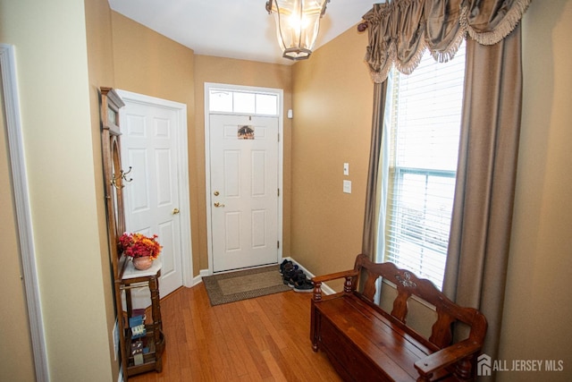 116 Prusakowski Blvd, Sayreville, NJ 08859 - foyer entrance with plenty of natural light, light wood-style flooring, baseboards, and an inviting chandelier