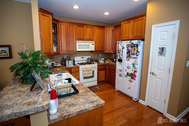 116 Prusakowski Blvd, Sayreville, NJ 08859 - kitchen featuring white appliances, brown cabinets, and light wood-style floors