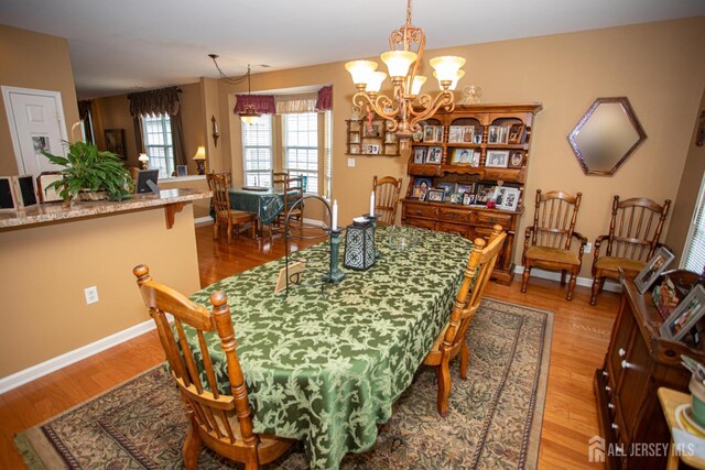 116 Prusakowski Blvd, Sayreville, NJ 08859 - dining space featuring baseboards, light wood-style floors, and a chandelier