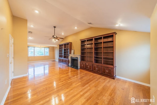 289 Old Rd, Sewaren, NJ 07077 - unfurnished living room with vaulted ceiling, light wood-style floors, a ceiling fan, baseboards, and a fireplace with flush hearth