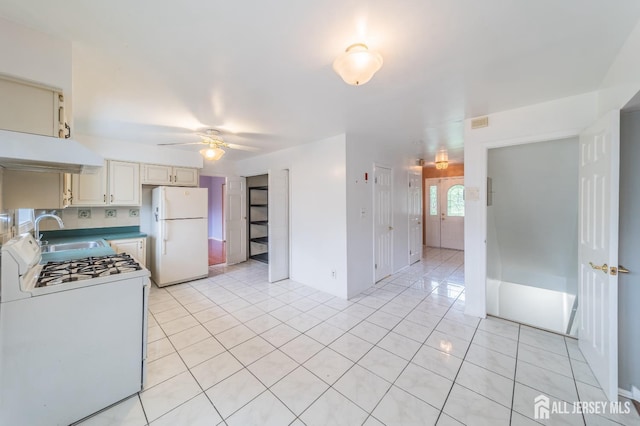 289 Old Rd, Sewaren, NJ 07077 - kitchen featuring white appliances, a sink, under cabinet range hood, and light tile patterned floors