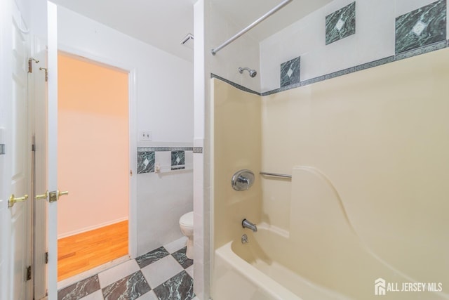 289 Old Rd, Sewaren, NJ 07077 - full bathroom featuring toilet, tub / shower combination, and tile walls