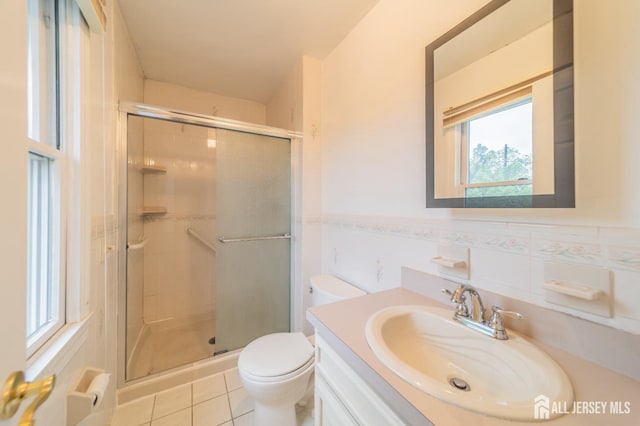 289 Old Rd, Sewaren, NJ 07077 - full bathroom featuring vanity, toilet, a shower stall, tile patterned flooring, and wainscoting
