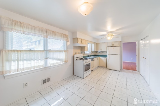 289 Old Rd, Sewaren, NJ 07077 - kitchen with white appliances, a sink, ceiling fan, cream cabinets, and light tile patterned flooring