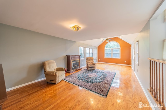 289 Old Rd, Sewaren, NJ 07077 - living area with light wood-style floors, ceiling fan, a glass covered fireplace, vaulted ceiling, and baseboards