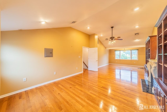 289 Old Rd, Sewaren, NJ 07077 - unfurnished living room with lofted ceiling, baseboards, ceiling fan, light wood finished floors, and electric panel