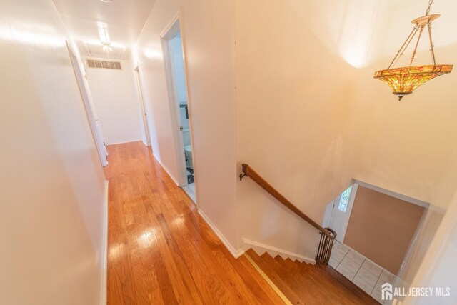 289 Old Rd, Sewaren, NJ 07077 - hallway featuring an upstairs landing, light wood-type flooring, and attic access