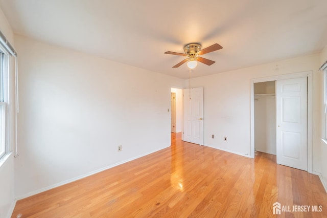 289 Old Rd, Sewaren, NJ 07077 - unfurnished bedroom with a closet, light wood-style floors, baseboards, and ceiling fan