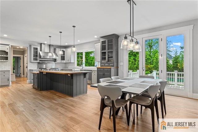 dining space with light wood finished floors and recessed lighting
