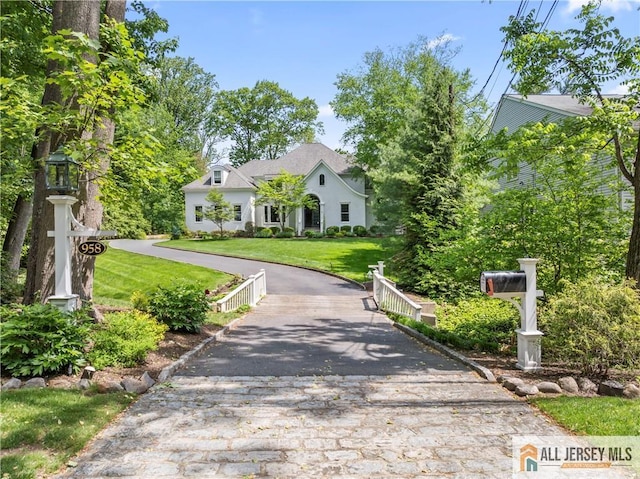 view of front of home with a front lawn and asphalt driveway